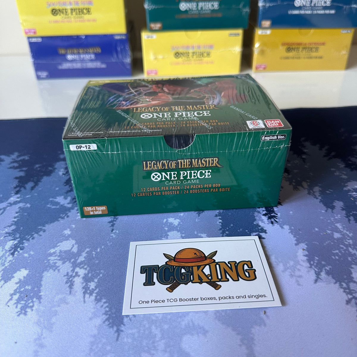 One Piece OP12 Legacy of the Masters English booster box, top and side view