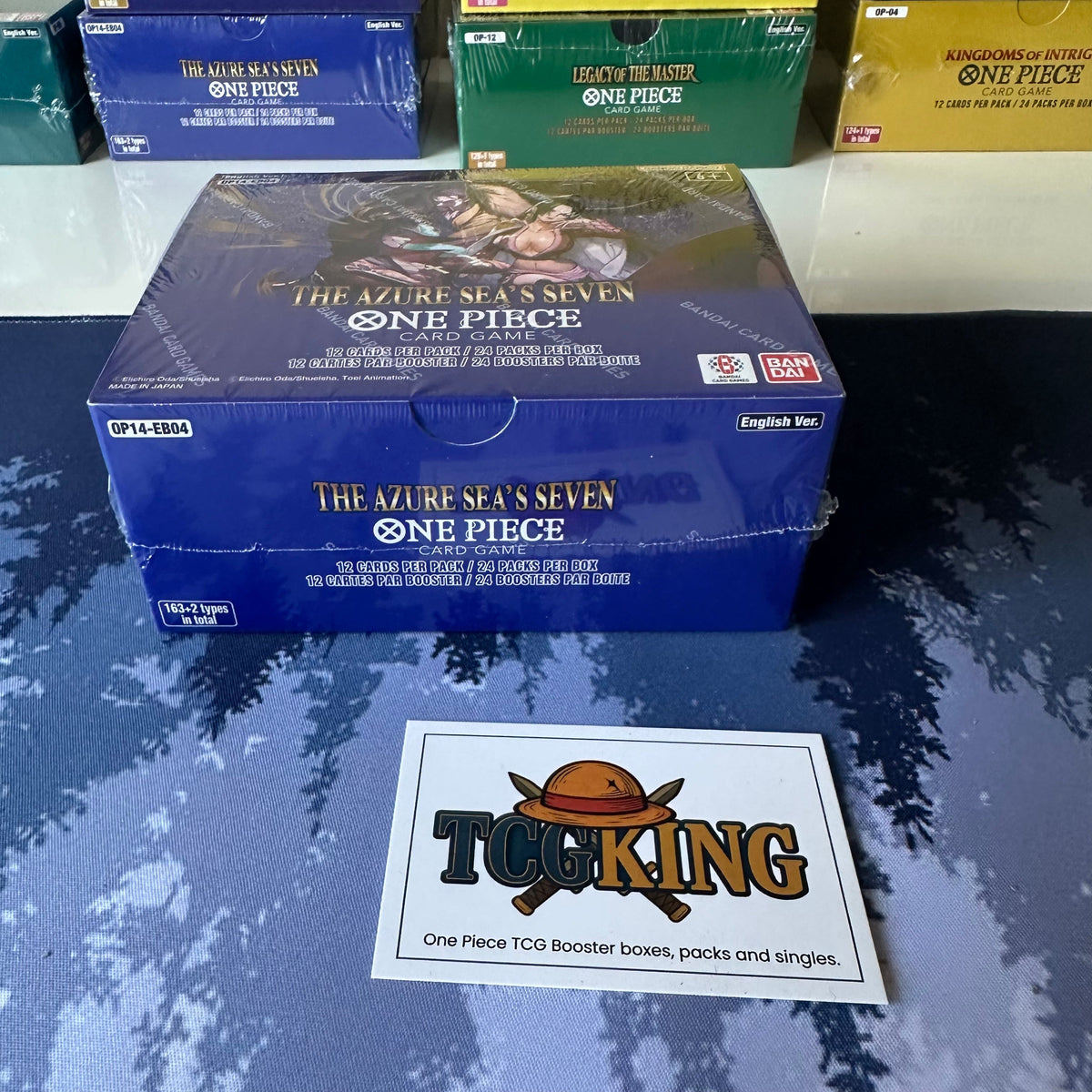 One Piece OP14-EB04 The Azure Sea's Seven English booster box, top and side view